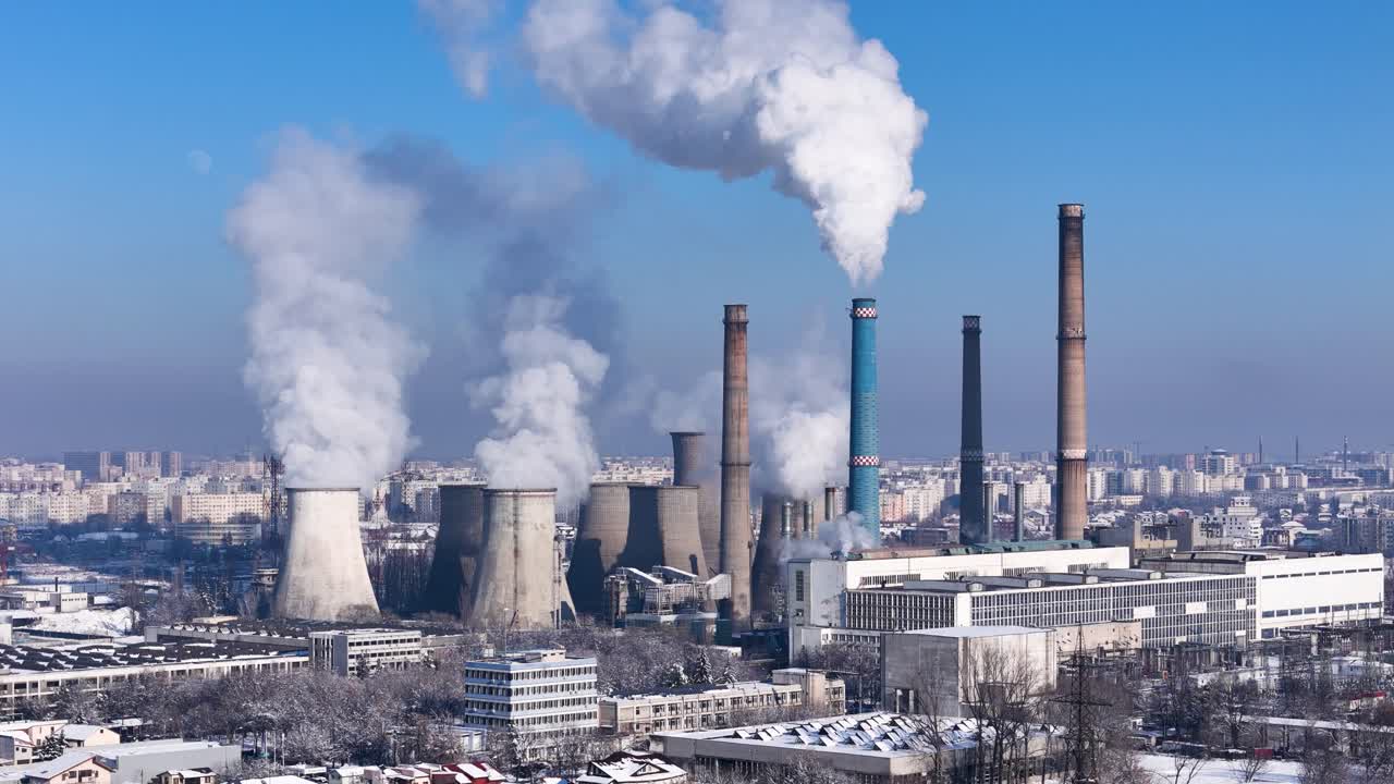 Aerial View Of A Energy Power Plant Releasing White Smoke In The Atmosphere With A City In The Background, Bucharest, Romania