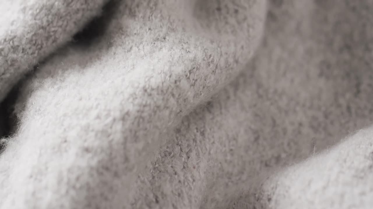 복사 공간과 함께 회색 양털 직물의 클로즈업의 마이크로 비디오