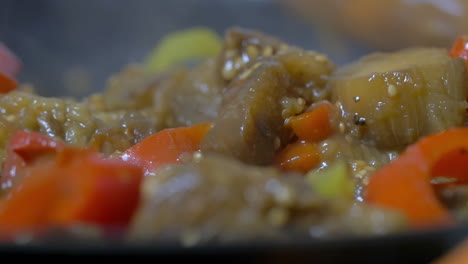 vegetable stew stirring with wooden spoon in pan