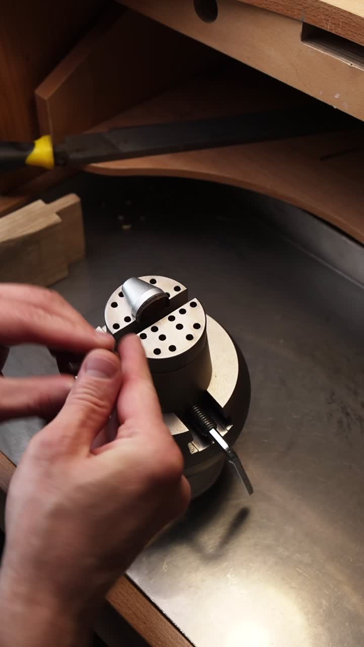 Close-Up of Jeweler's Hands Assembling an Engraving Block