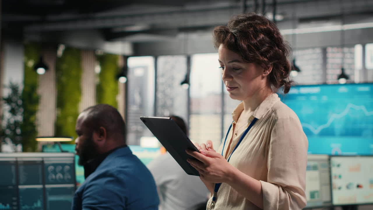 Vertical Video Woman business consultant examines charts and icons on tablet