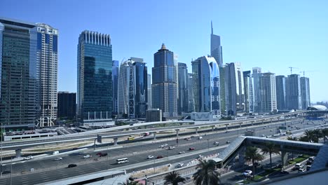 traffic flows along dubai's sheikh zayed road, with a view of jumeirah lake towers at dubai marina, uae
