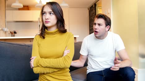 couple sitting at table and calculating bills