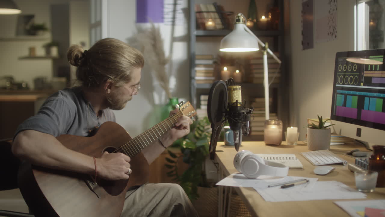 Musician Playing Guitar in Home Recording Studio