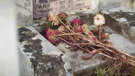 decaying flowers on a tomb