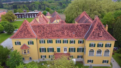 Beautiful-view-from-above-of-Kalsdorf-Castle,-Neudorf-Bei-Ilz,-Austria,-includes-exterior-architecture-view-contains-windows,-gateway,-trees