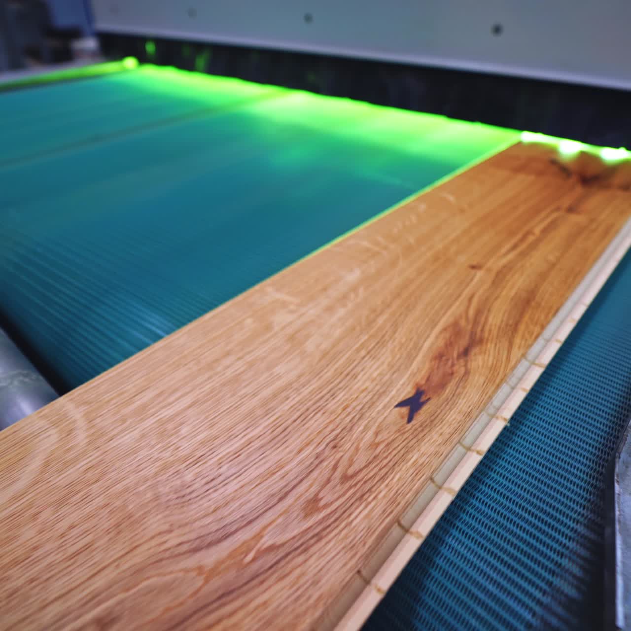 Parquet factory. Wooden laminate board moving on a conveyor line inside the modern industrial plant. Furniture production.