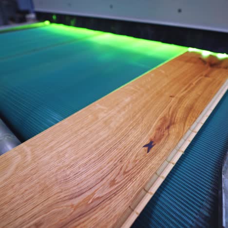 parquet factory. wooden laminate board moving on a conveyor line inside the modern industrial plant. furniture production.