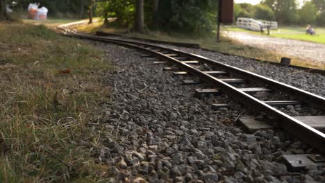 Monorail-train-track-in-park-wide-tilting-shot