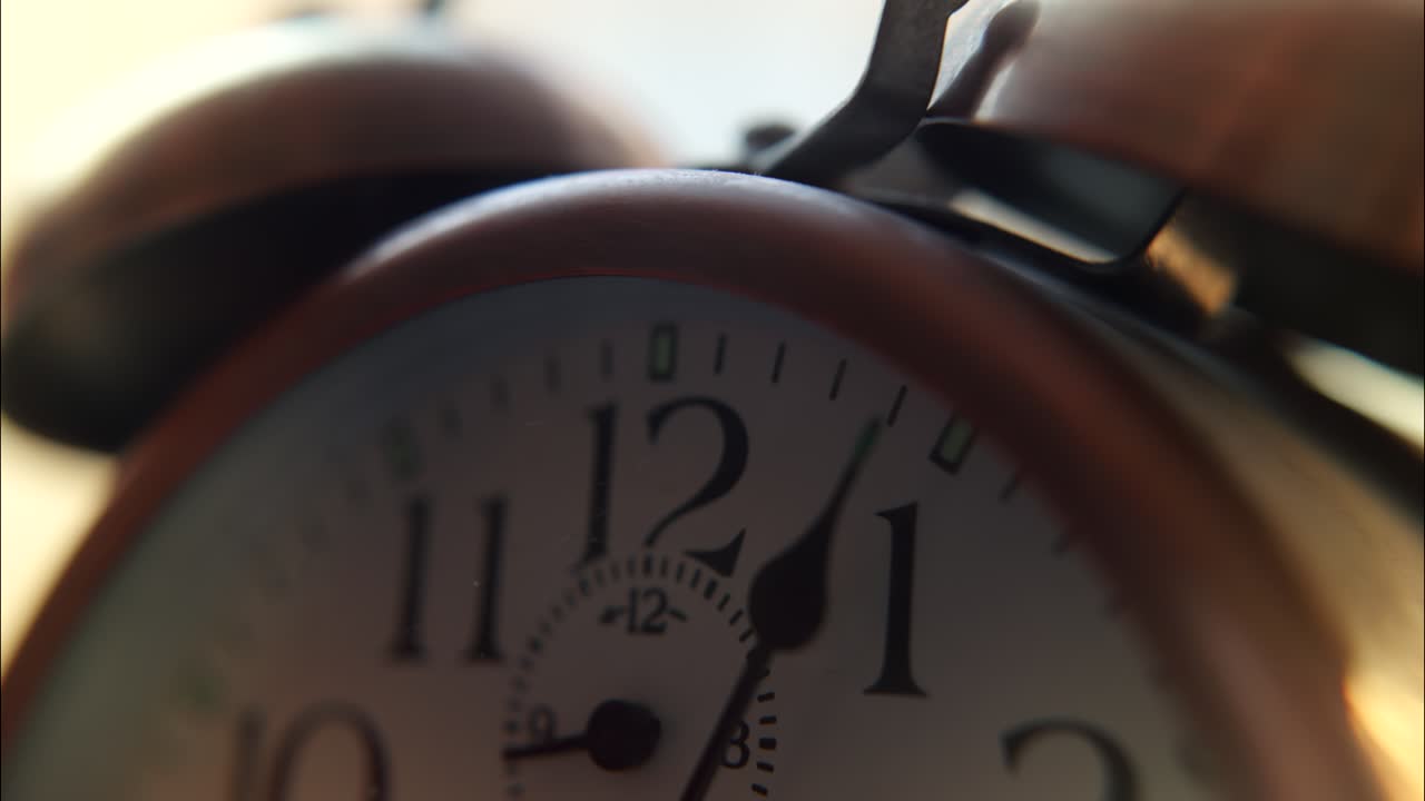 Close-up of a Vintage Alarm Clock with Ticking Hands
