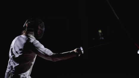 two fencers in a competitive match