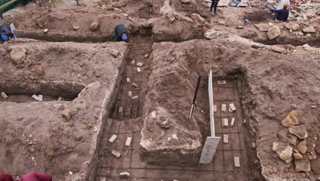 trenches for a house foundation being excavated on a building site near a river with steel reinforcement