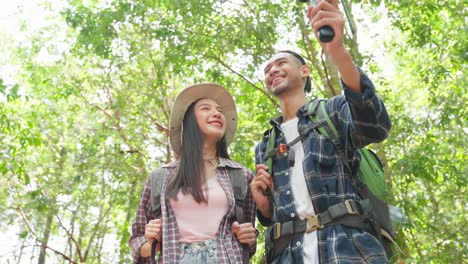 couple hiking and taking a selfie in the woods