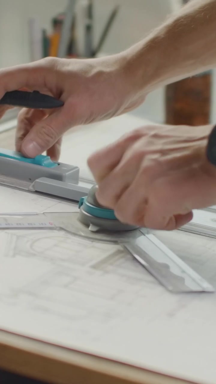 Architect Adjusting Drafting Tool on Blueprint in Studio