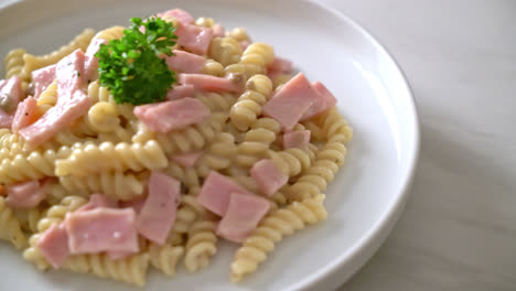 spirali or spiral pasta mushroom cream sauce with ham - italian food styl