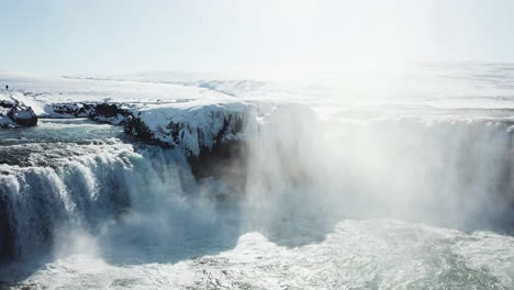 beautiful drone shot of frozen waterfall in iceland