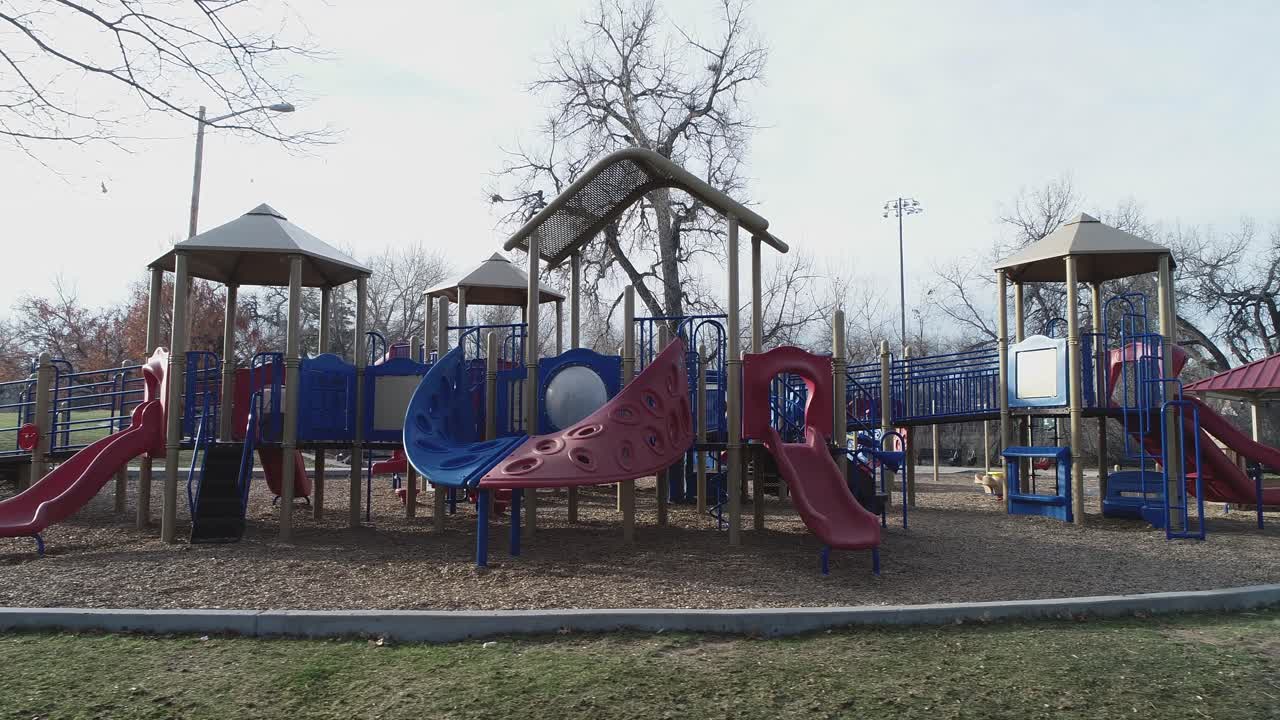 Right dolly aerial of playground with no children due to COVID virus