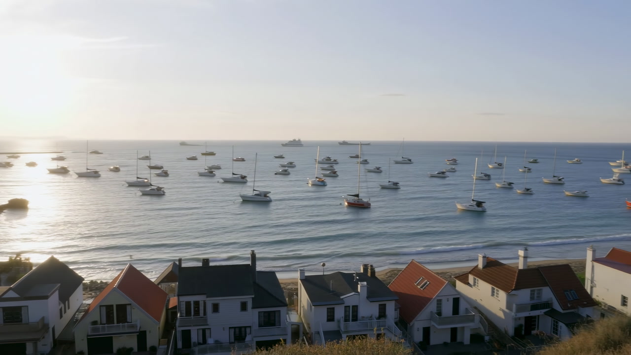 Sunrise Harbor With Anchored Boats Coastal Homes Overlooking Calm Bay, Soft Sunlight Reflecting On Water