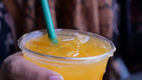 orange juice in a plastic cup