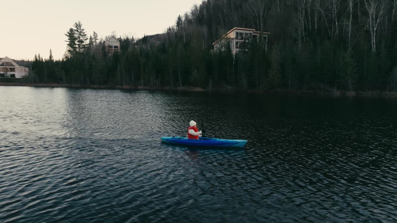 Tourist Oaring While Kayaking In Lake - drone shot