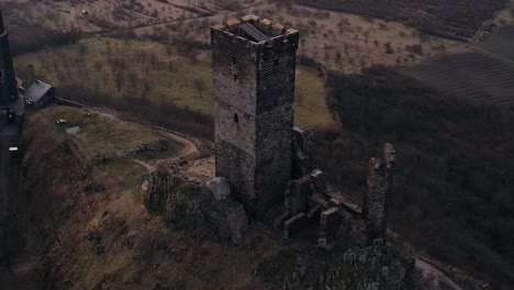 Establishing-shot,-cinematic-drone-view-of-hilltop-medieval-castle-with-ramparts