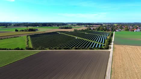 aerial-flight-over-solar-farm-in-summer,-4k