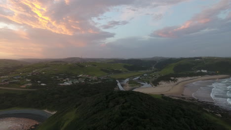 cinematic aerial flying at sunrise over coast of east london south africa