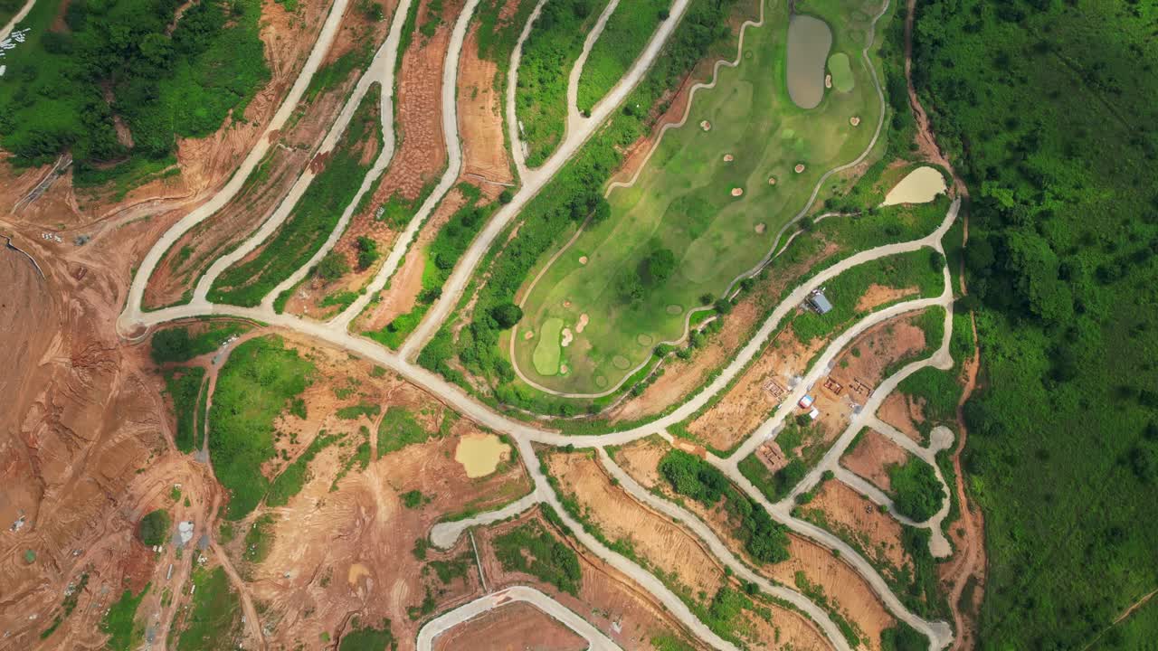 A top-view aerial of Tandatangan Signature Golf Course with winding fairways and forest edges in Mariveles, Bataan, Philippines