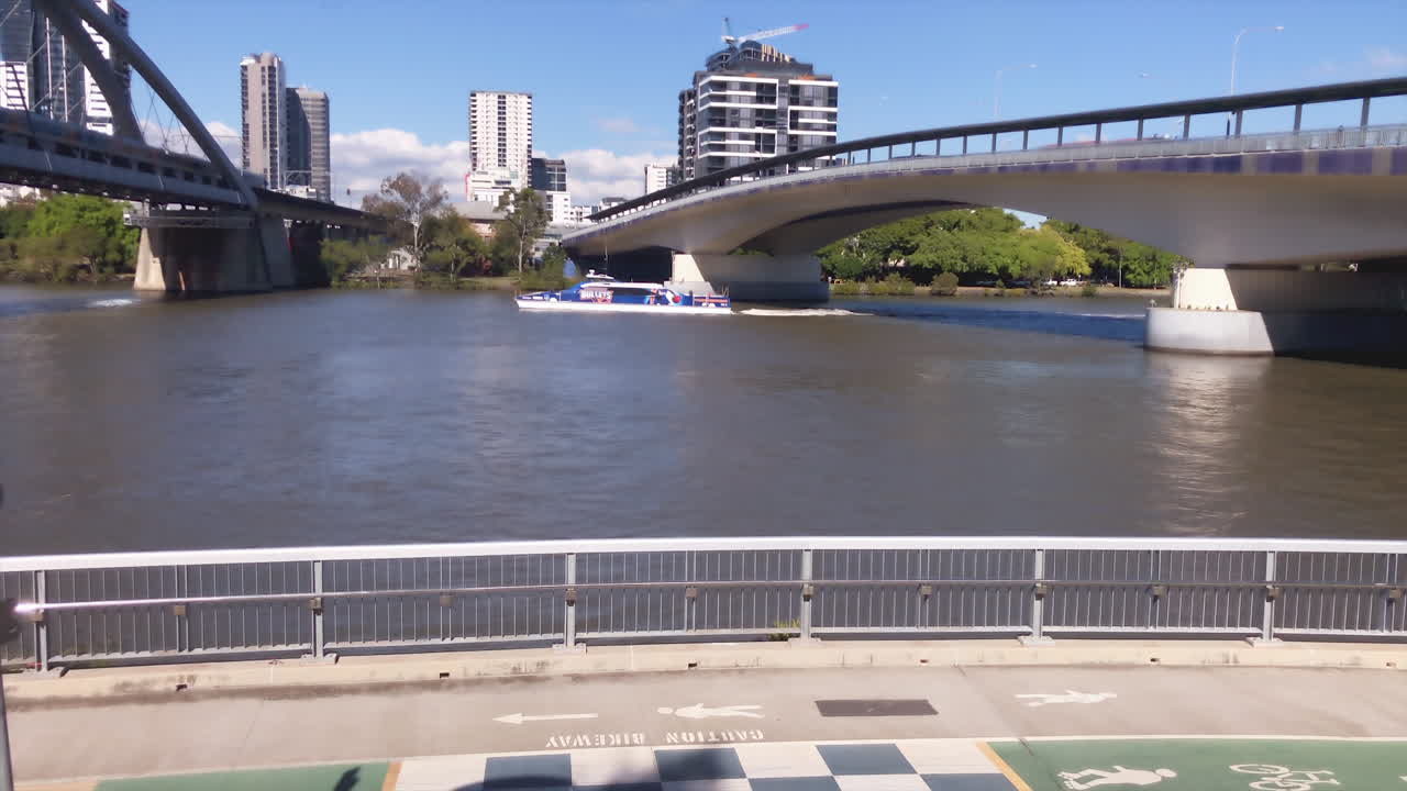 Brisbane City Cat sails under bridge