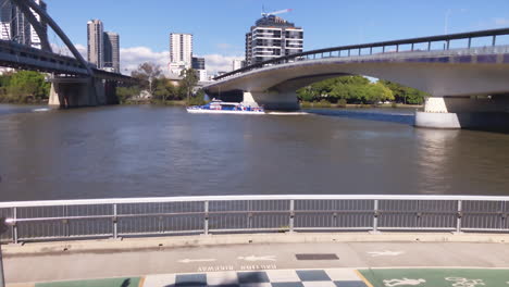 brisbane city cat sails under bridge