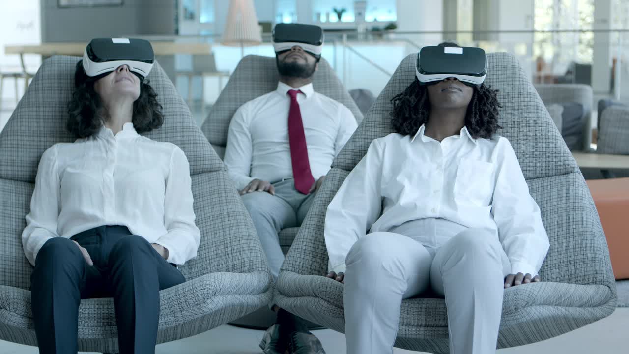 Relaxed business team in vr headsets