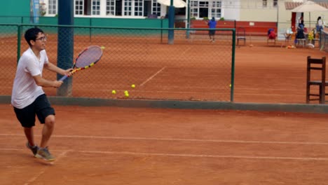 slow motion of tennis player practicing on tennis court, hitting ball hard