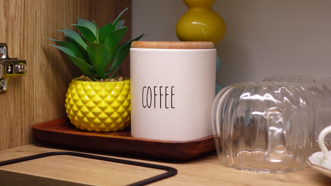 Coffee Canister and Decorative Items on a Kitchen Shelf