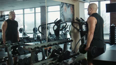 Man Working Out With Dumbbells in a Gym