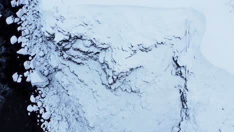 snowy volcanic cliffs in iceland, aerial