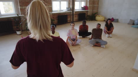 group of diverse students listening to dance teacher