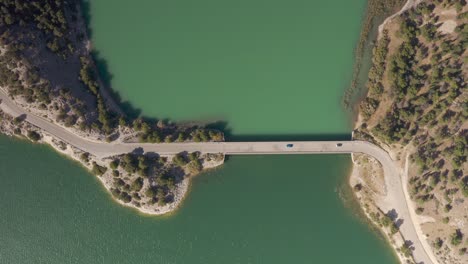 aerial view of a bridge spanning a turquoise lake