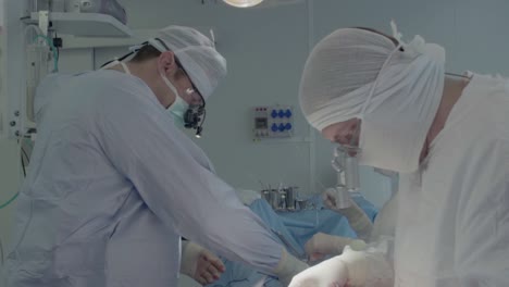 medical staff during a heart operation 1 the surgeon selects the instruments