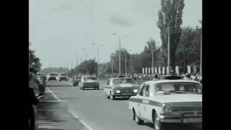 street scene with parade and crowds in soviet era