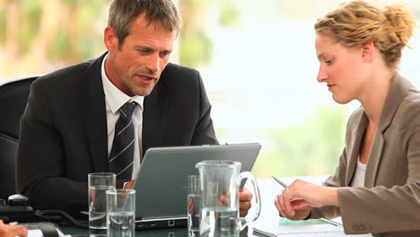 Threesome-of-business-people-during-a-meeting