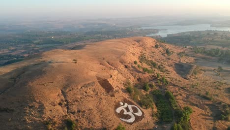 Yoga-Vidya-Gurukul-|-Om-on-the-hill-|-Peace-|-Aerial-Footage-from-Nashik,-India