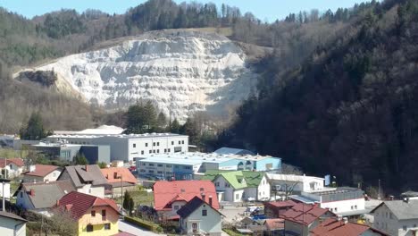 revealing traditional slovenian village and steep mountain background, aerial backward