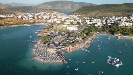 packed beach with aqua play at the city of ksamil in the albanian riviera