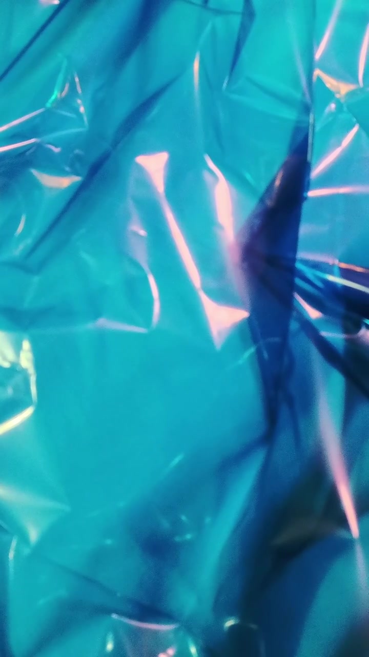Abstract Background of Shimmering Blue Iridescent Plastic Film