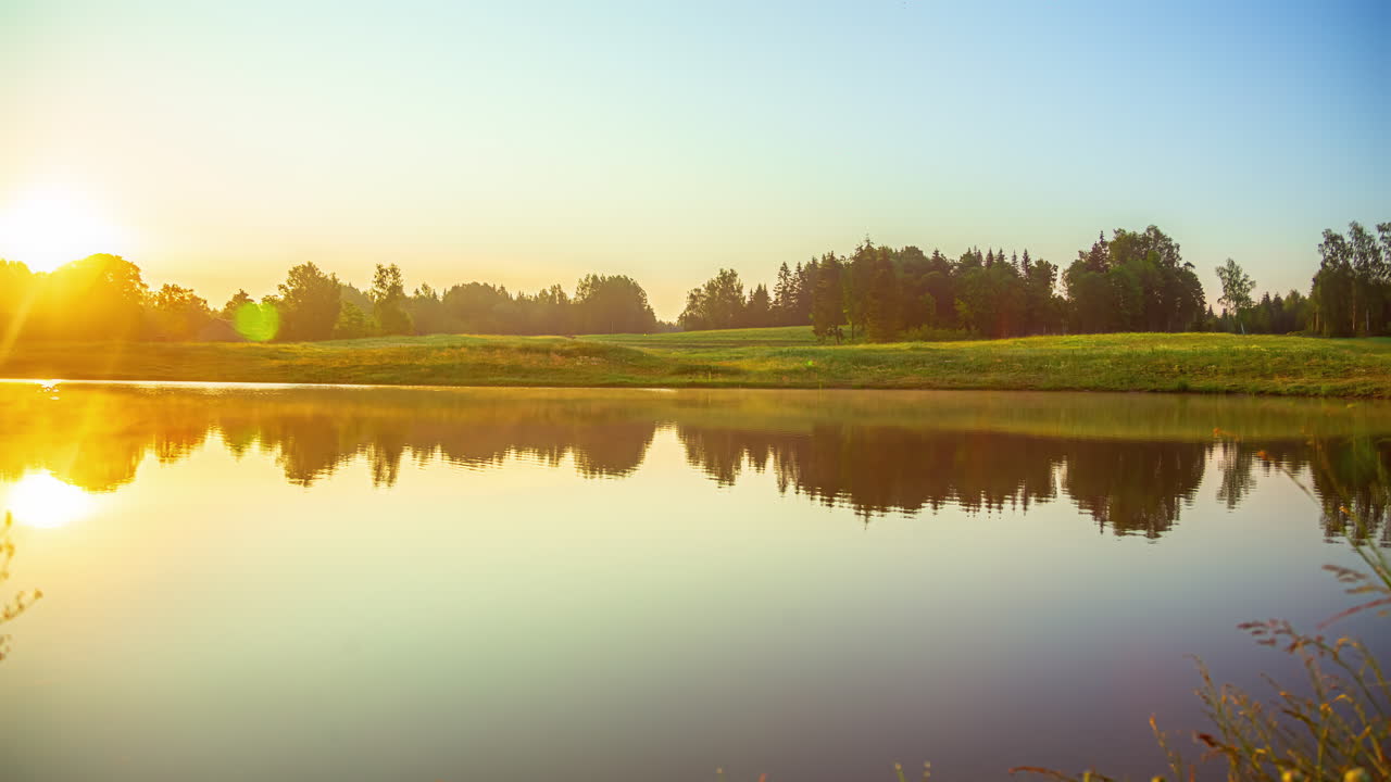 It brilliantly captures the sunrise, highlighted by its radiant reflection dancing on the lake's surface