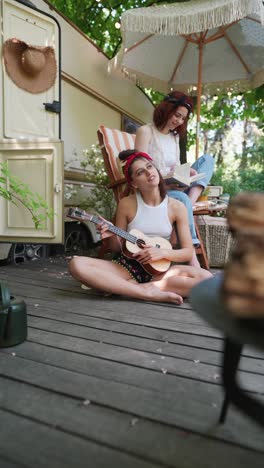 friends playing ukulele on camping trip