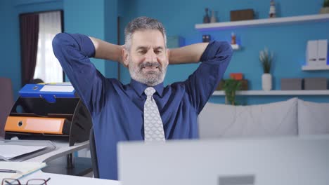 Mature-businessman-working-in-home-office-completing-his-work,-relaxing-and-being-happy.