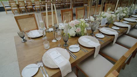 Elegant place settings arranged on a long table, ready for a beautiful evening dinner