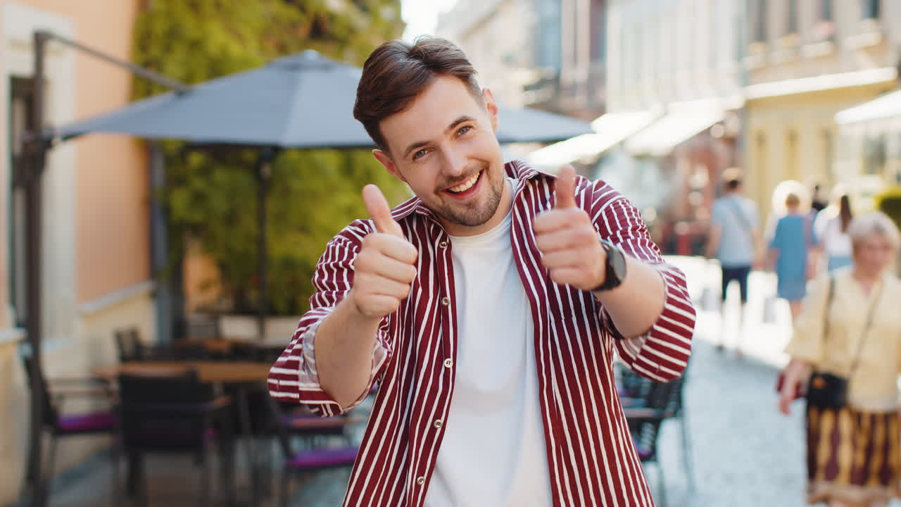 Happy man showing thumbs up like sign positive something good positive feedback in city street