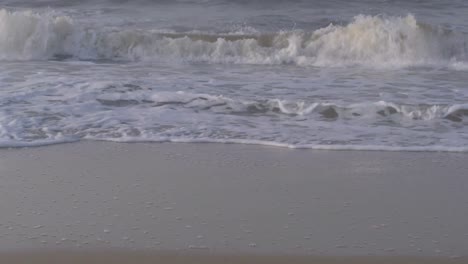 waves of the caribbean sea breaking on the beach